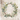Wreath with greenery around it