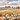 Painting of pumpkins in a field with a barn and trees, 