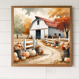 Framed artwork of a barn scene with pumpkins and autumn trees on a white wooden wall.