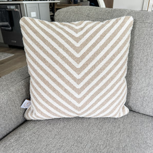 Striped pillow on a gray couch in a living room setting