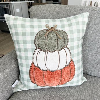 Stacked pumpkin trio pillow cover with green checked background 