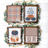 Set of four framed prints with autumn-themed designs on a decorative background.