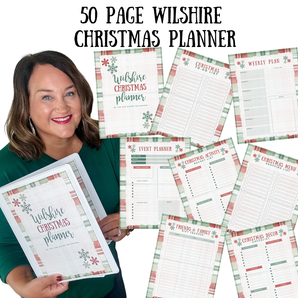 Woman holding a 50-page Wilshire Christmas planner with various planning sheets displayed.