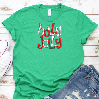 flat lay of holly jolly christmas t shirt on green 