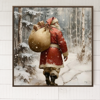 Framed artwork of a Santa Claus figure with a large sack walking through a snowy forest.