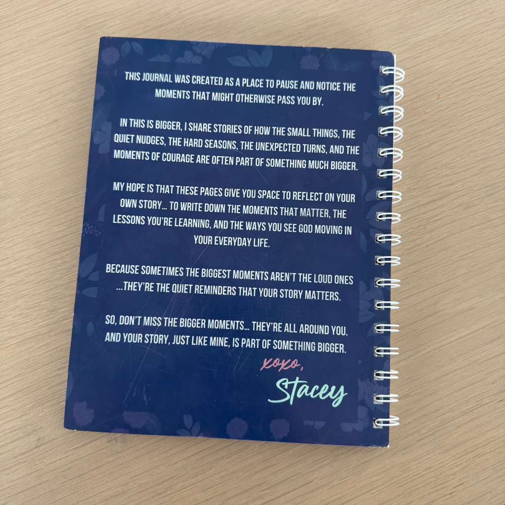Blue notebook with text on a wooden surface