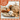 Decorative fall arrangement with pumpkins and dried elements on a plaid background