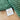 Green textured fabric with a 'Wilshire WC Collections' label on a wooden surface
